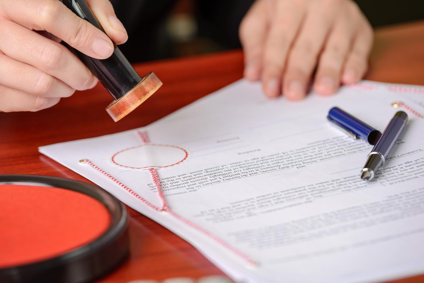 A formal document being stamped by a notary