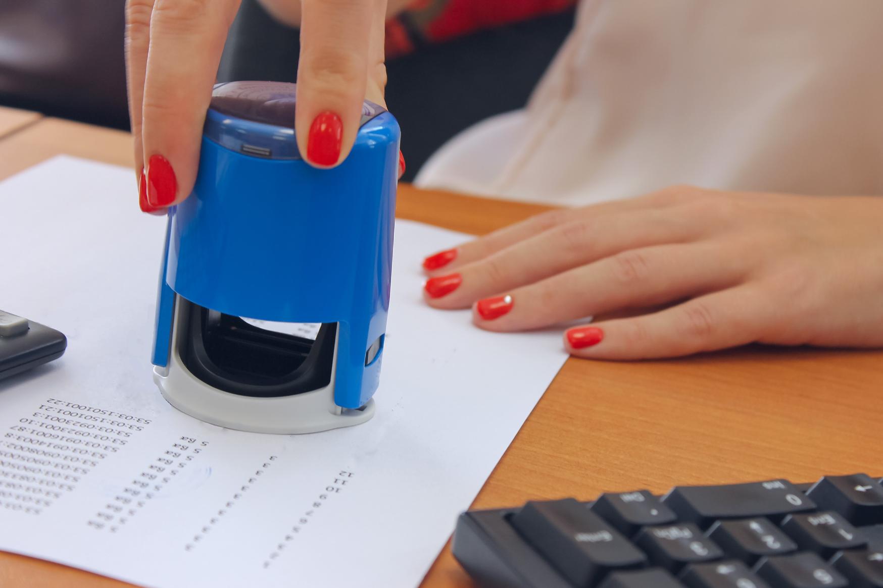 A formal document being stamped by a notary