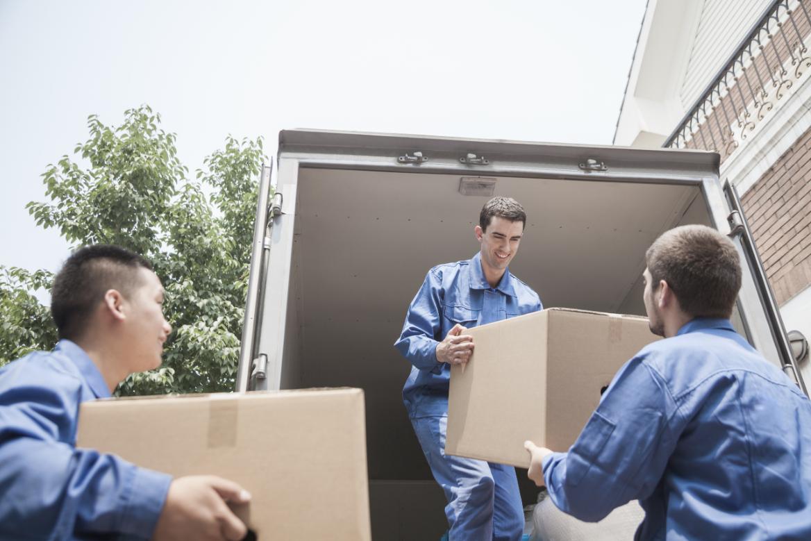 A team of men loading boxes into a van