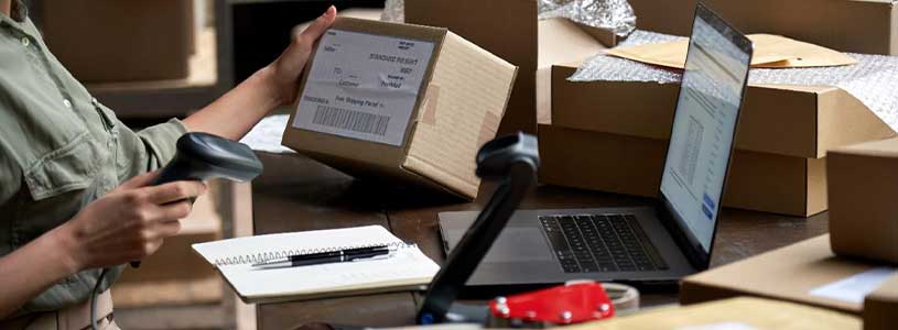 An employee scanning a package on a laptop